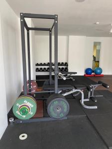 a room with a gym with weights and a mirror at Family stay, sepang KLIA, free 2 parking&Unifi in Sepang