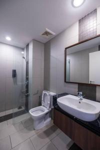 a bathroom with a sink and a toilet and a shower at Deluxe Seaview Suite Twin Bed by The Only Bnb in Tanjong Tokong