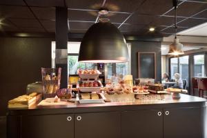 a bakery with a counter with food on it at Campanile Toulon - La Seyne sur Mer - Sanary in Six-Fours-les-Plages