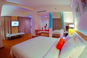 Voodi või voodid majutusasutuse HARRIS Hotel & Conventions Malang toas