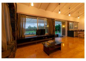 a living room with a television and a table at Stone Cold 2BHK in Nashik