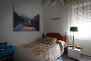 a bedroom with a bed and a picture on the wall at Casa rural Arribes Vida in Vitigudino +19 photos