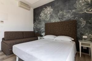 Postel nebo postele na pokoji v ubytování Hotel President