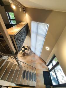a spiral staircase in a house with a table at Kotedža “Saules osta” in Saulkrasti