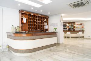 a bar in a room with a counter at Hotel La Mela in Varcaturo