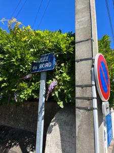 un panneau bleu devant une brousse dans l'établissement La Ruelle des Bords de Loire - Classé 2**, à Basse-Indre