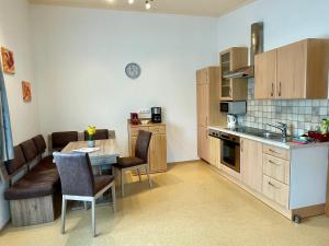 a kitchen with a table and a dining room at Appartements Sonnwies in Schladming