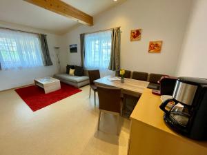 a living room with a table and a couch at Appartements Sonnwies in Schladming