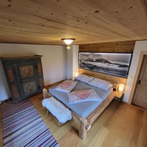 a bedroom with two beds in a wooden room at Sonnreichalm 