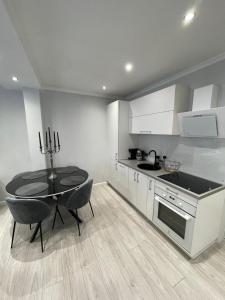 a kitchen with a table and a dining room at Brother street apartment in Liepāja