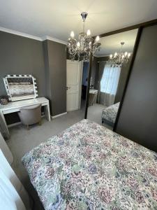 a bedroom with a bed and a desk and a mirror at Brother street apartment in Liepāja