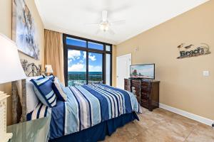 a bedroom with a bed and a view of the ocean at The Oasis at Orange Beach Condos by Hosteeva in Orange Beach