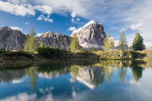 a mountain reflected in a lake in the mountains at HOTEL de LEN in Cortina dʼAmpezzo