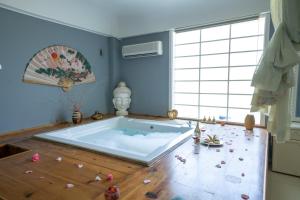 a jacuzzi tub in a room with a floor at Lykia Botanika Beach Fun & Club - All Inclusive in Fethiye