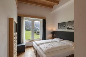 Posteľ alebo postele v izbe v ubytovaní ArlBerglife Ferienresort