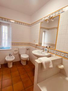 a bathroom with a sink toilet and a mirror at Casa Pereiro playa de Esteiro in Viveiro +45 photos