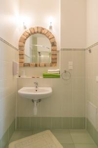 a bathroom with a sink and a mirror at Viesu māja Jānis in Madona