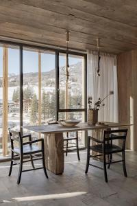uma sala de jantar com uma grande mesa de madeira e cadeiras em HOTEL de LEN em Cortina dʼAmpezzo