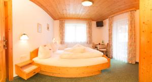 a bed in a room with a wooden ceiling at Haus Elisabeth in Neustift im Stubaital
