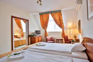 Postel nebo postele na pokoji v ubytování Hotel Rittinger