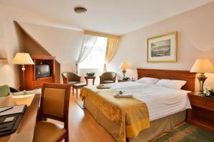 Postel nebo postele na pokoji v ubytování Hotel Rittinger