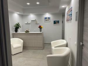 a waiting room with two chairs and a reception desk at Aedes Tropea B&B in Santa Domenica