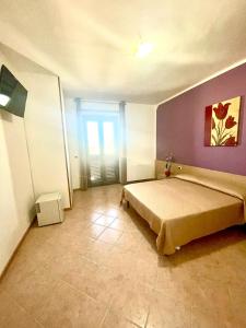 a bedroom with a large bed and a window at Vacanze Da Annalisa in Centola