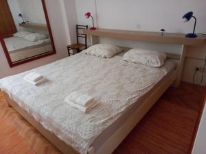 a bedroom with a bed with two towels on it at Kuća za odmor Ljubica Šibenik in Šibenik
