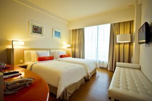 Voodi või voodid majutusasutuse HARRIS Hotel & Conventions Malang toas