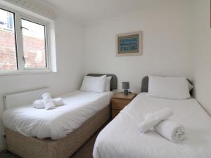 two beds sitting next to each other in a room at Seaview in Weymouth