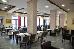 a dining room filled with tables and chairs at Hotel Javor in Kušići