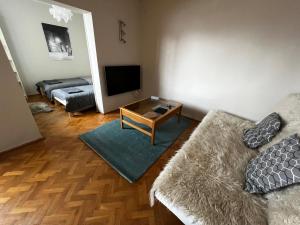 a living room with a couch and a television at Do Gdyni in Gdynia