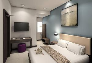 a hotel room with a bed and a tv at Beryll Inn Cyberjaya Hotel in Cyberjaya