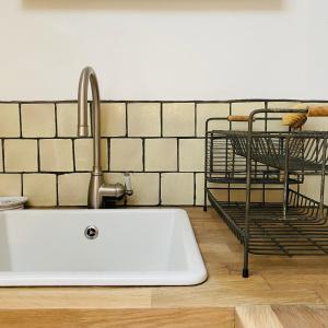 a kitchen sink with a faucet on top of it at The Pavement Palace in Hay-on-Wye +27 photos