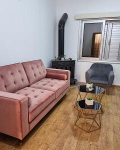 a living room with a pink couch and a chair at Casa Di Anna in Agros