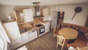 a small kitchen with a table and a dining room at Ferienhaus Kaltenbrunn in Ellmau