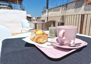 a table with two cups of coffee and a pastry at B&B Tra le vie del borgo in Vieste