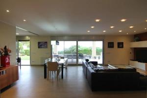 a large living room with a couch and a table at VILLA MARICEL in Alcanar