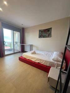 a bedroom with a bed with a red frame at VILLA MARICEL in Alcanar