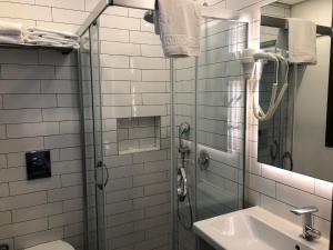 a bathroom with a shower and a toilet and a sink at Yerli Alaçatı in Alaçatı +26 photos