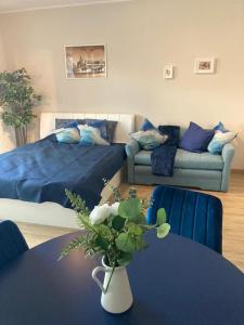 a living room with a couch and a table with a vase at Wiślane Tarasy 2.0, free parking, private garden in Kraków