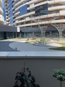 a building with a fountain in front of a building at Wiślane Tarasy 2.0, free parking, private garden in Kraków