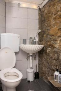a bathroom with a toilet and a sink at Caviro - traditional stone house in Chora in Samothraki
