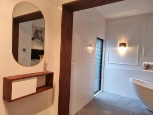 a bathroom with a sink and a mirror at RESIDENTIAL 4 BEDROOM House in Coffs Harbour