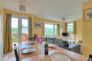 a dining room with a table with wine glasses at Charlesmead in Uplyme