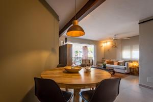 a dining room with a wooden table and chairs at K-TERRA by Nuka Homes in Jávea +17 photos