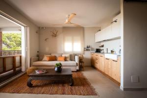 a living room with a couch and a table at K-TERRA by Nuka Homes in Jávea