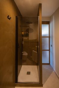 a shower with a glass door in a bathroom at K-TERRA by Nuka Homes in Jávea