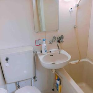 a bathroom with a sink and a toilet and a mirror at Jinpachi Building - Vacation STAY 64315v in Gifu