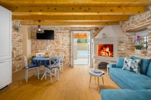 a living room with a blue couch and a fireplace at Villa Ivea in Višnjan